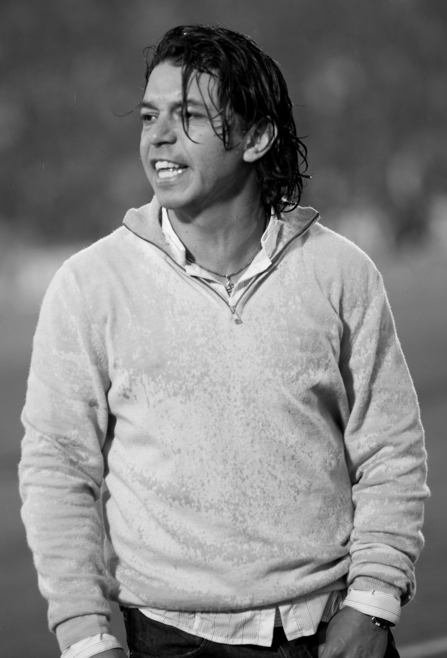 Black and white photo of Marcelo Gallardo on the touchline in a light sweater